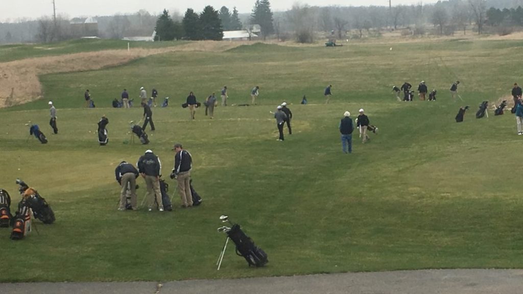 golfers gathering around the course